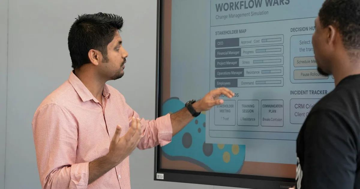 Two business professionals reviewing customer records on a screen — WeIntegrate auto-creates new Shopify customers in QuickBooks Online