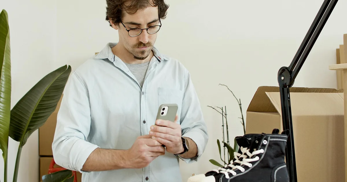 Shopify merchant photographing a product with a smartphone for an online listing — WeIntegrate auto-creates new items in QuickBooks Online