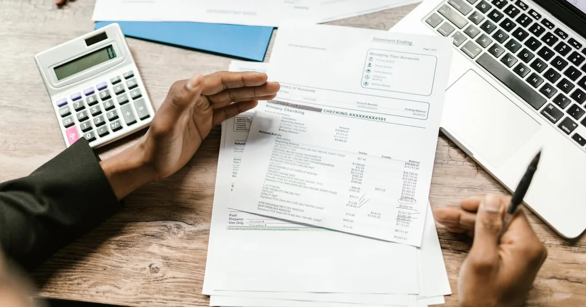 Business professional reviewing international tax data on laptop — Shopify import tax account in QuickBooks Online payout deposit