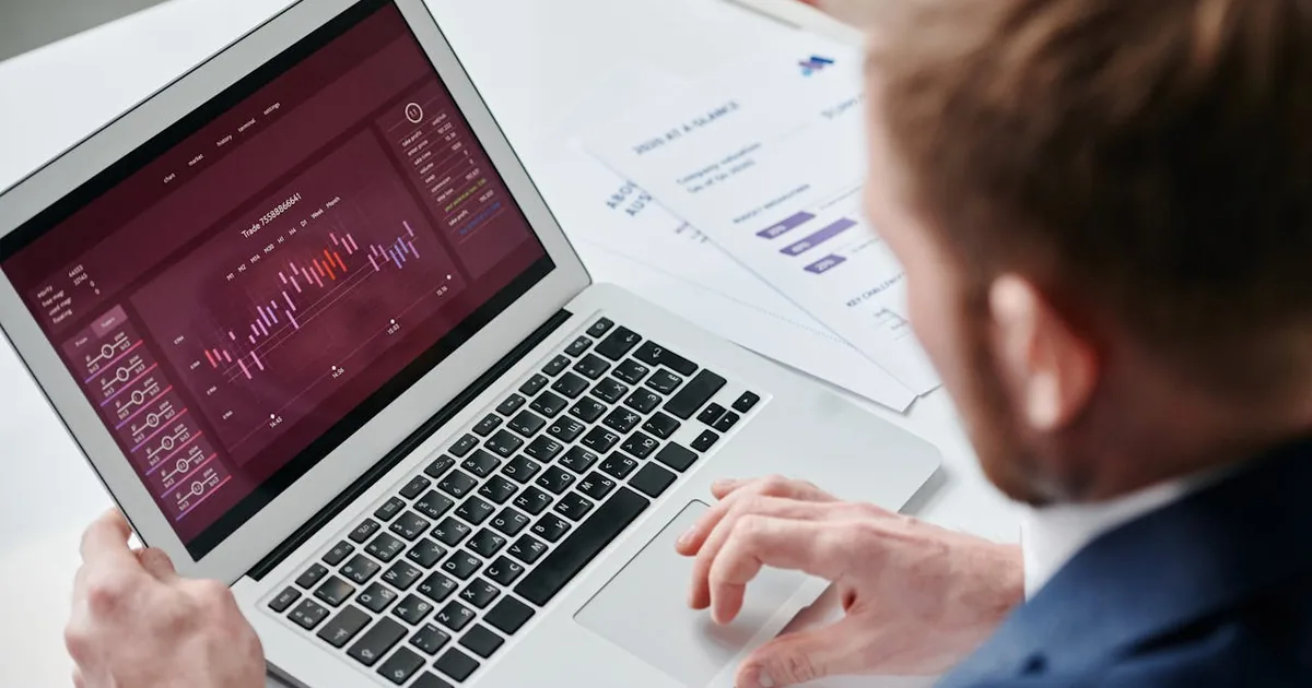 Businessman reviewing analytics dashboard on laptop — Shopify to QuickBooks Online integration setup and per-transaction record accuracy